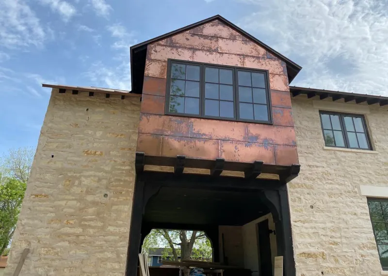 Copper metal panel facade on a stone building for Roof Repair in Salt Lake City
